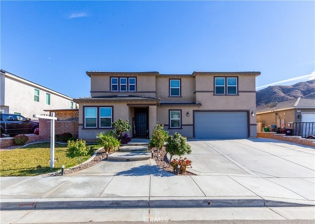 view of front of property with a garage, driveway, and stucco siding