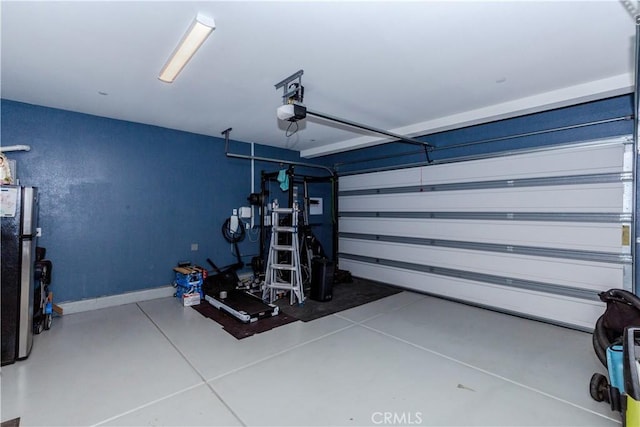 garage featuring a garage door opener and baseboards