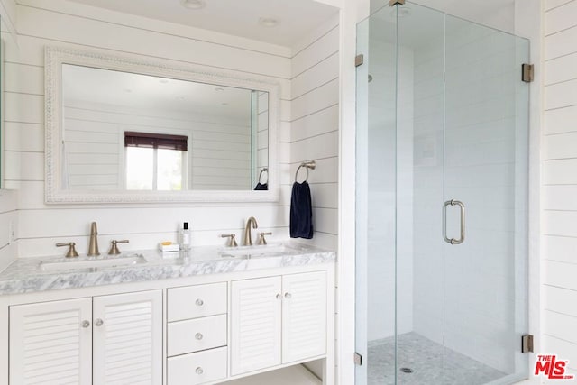 bathroom featuring vanity, walk in shower, and wood walls