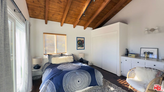 bedroom with vaulted ceiling with beams and wood ceiling