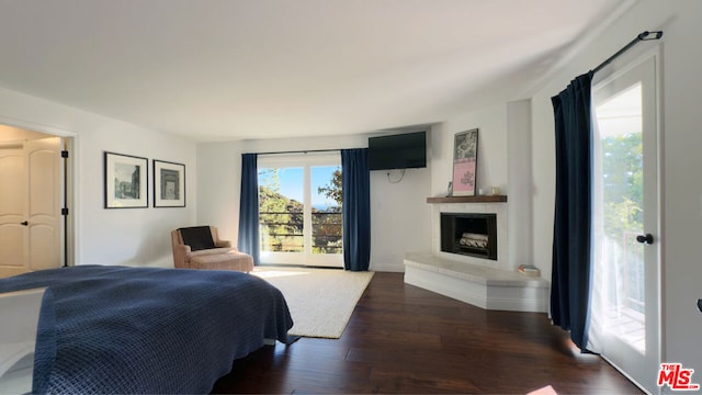 bedroom featuring access to exterior and dark hardwood / wood-style flooring