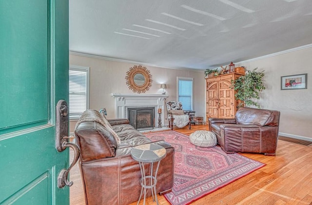 living room with plenty of natural light, wood-type flooring, and crown molding