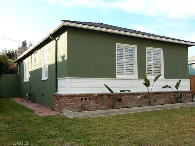 view of side of property with a yard