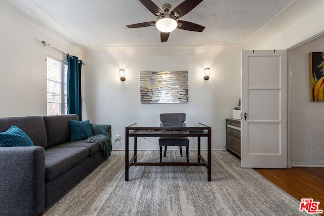 office space with ceiling fan, wood-type flooring, and a textured ceiling