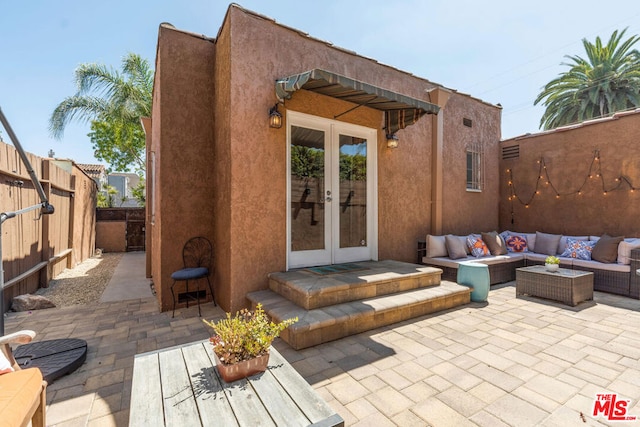 back of property featuring a patio area, an outdoor hangout area, and french doors