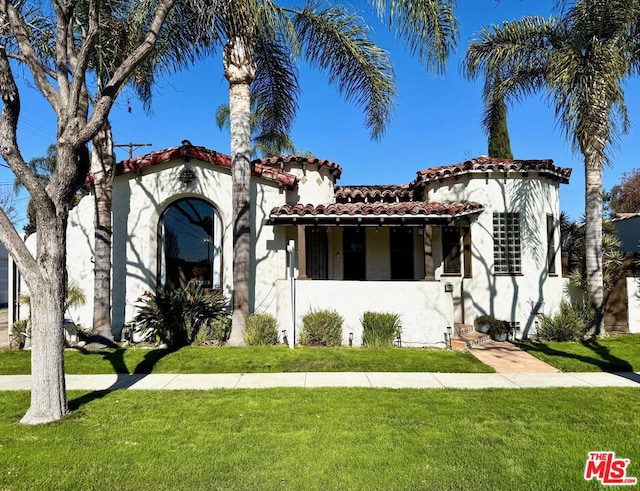 mediterranean / spanish-style house with a front lawn