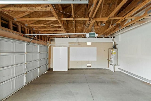 garage with strapped water heater and a garage door opener