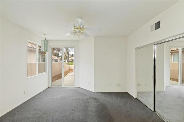 carpeted empty room featuring ceiling fan