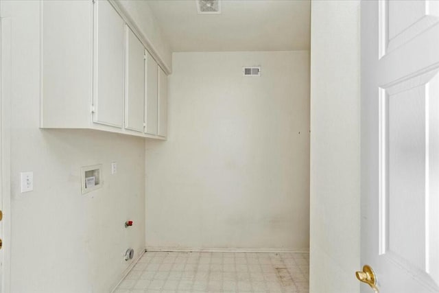 laundry area featuring hookup for a washing machine and cabinets