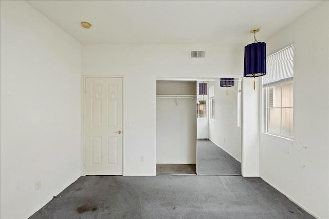 unfurnished bedroom featuring dark carpet