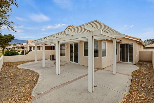 rear view of property with a patio area and a pergola