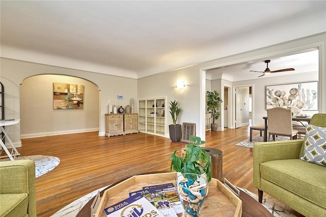 living room with ceiling fan and hardwood / wood-style floors