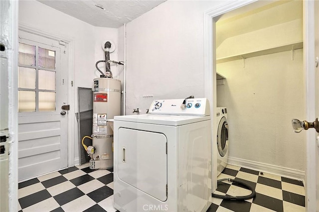 washroom featuring washing machine and dryer and strapped water heater