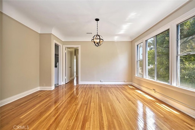 interior space featuring hardwood / wood-style flooring, ornamental molding, and a chandelier