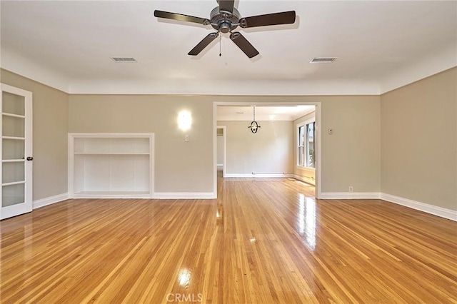 unfurnished living room with ceiling fan, built in features, and light hardwood / wood-style floors