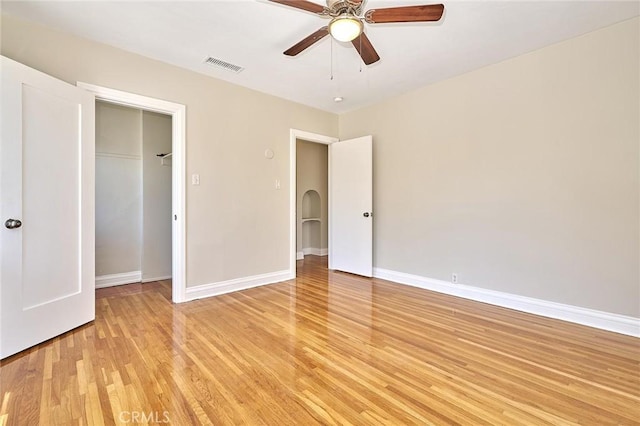 unfurnished bedroom featuring ceiling fan, a closet, and light wood-type flooring