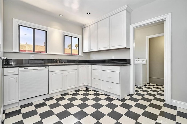 kitchen featuring washer / clothes dryer, dishwasher, white cabinets, and sink