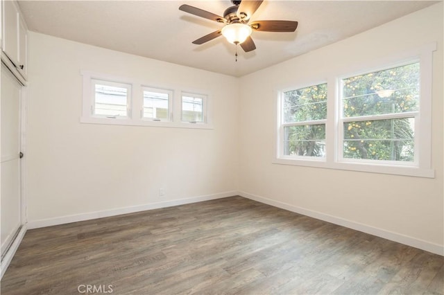 unfurnished room with ceiling fan and dark hardwood / wood-style flooring