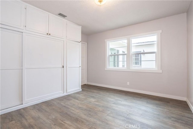 unfurnished bedroom featuring light wood-type flooring and a closet