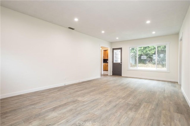 unfurnished room with light hardwood / wood-style floors