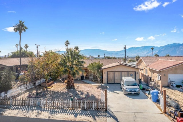 single story home featuring a mountain view and a garage