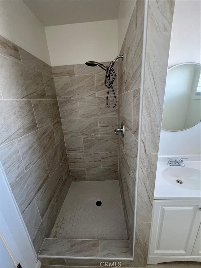 bathroom featuring a shower stall and vanity