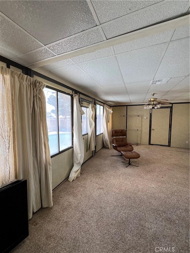 unfurnished room with carpet floors and a paneled ceiling