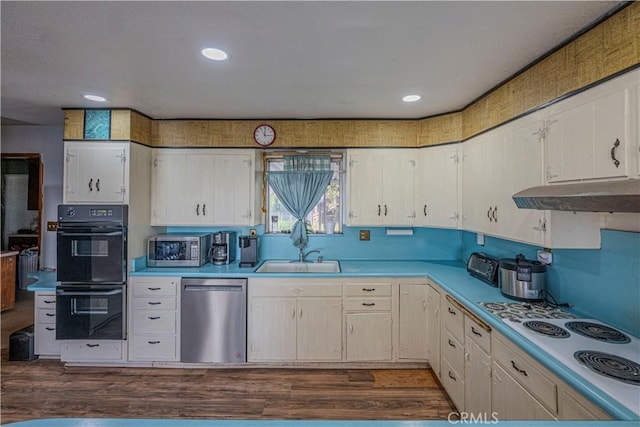 kitchen featuring white stovetop, dishwasher, dark hardwood / wood-style floors, and black double oven