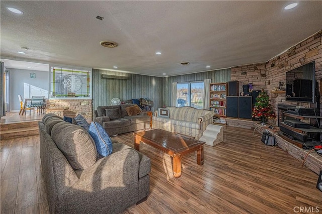 living room with a textured ceiling and hardwood / wood-style flooring