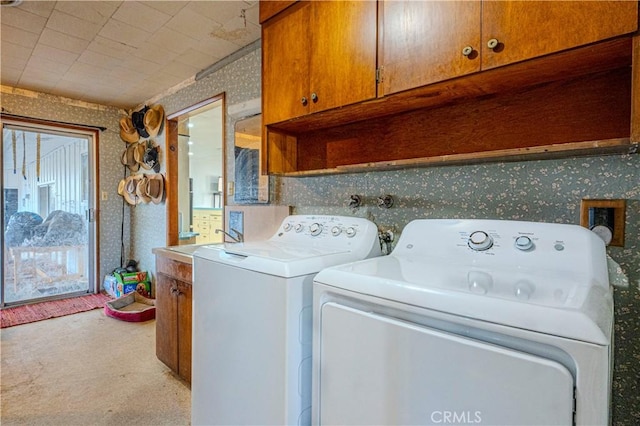 washroom featuring cabinets, carpet flooring, and washing machine and dryer