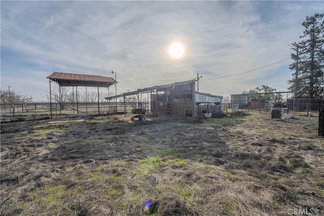 view of yard featuring a rural view and an outbuilding