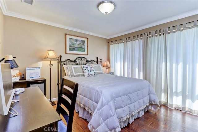 bedroom with dark wood-type flooring and ornamental molding