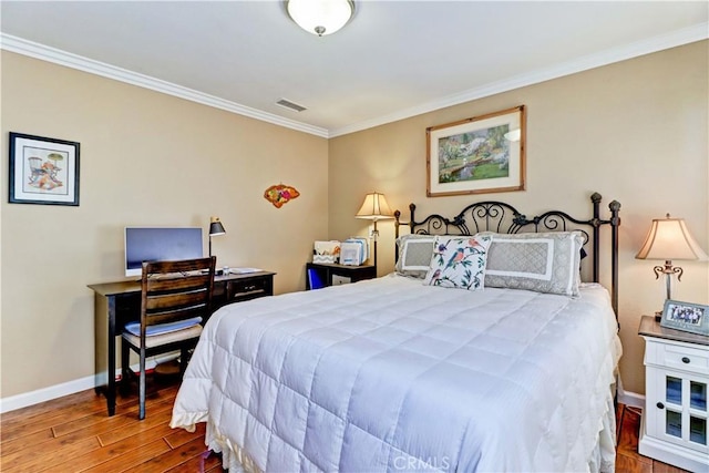 bedroom featuring hardwood / wood-style floors and crown molding