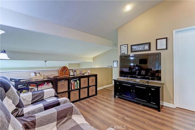 living room with light hardwood / wood-style flooring and vaulted ceiling