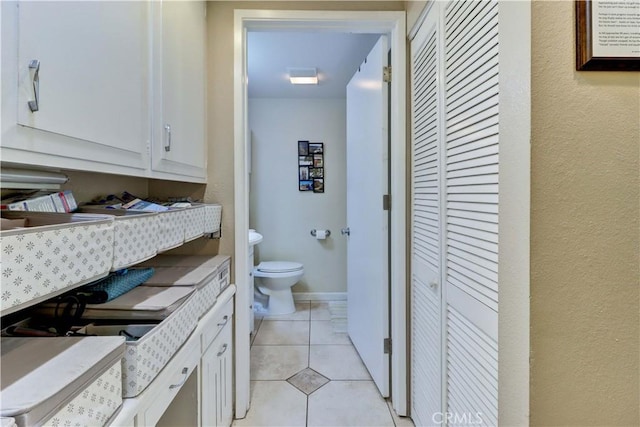 bathroom featuring tile patterned flooring and toilet