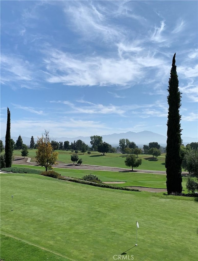 surrounding community featuring a lawn and a mountain view