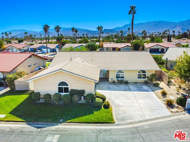 ranch-style house with a front yard and a mountain view