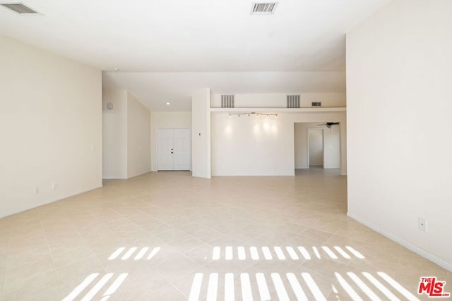 empty room featuring ceiling fan and light tile patterned floors