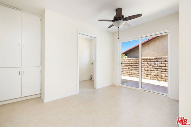 unfurnished bedroom featuring access to exterior, a closet, ceiling fan, and light tile patterned flooring