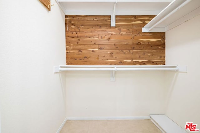 spacious closet with light tile patterned floors