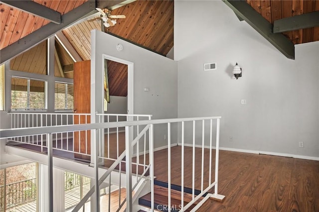 hall featuring beam ceiling, hardwood / wood-style flooring, high vaulted ceiling, and wooden ceiling