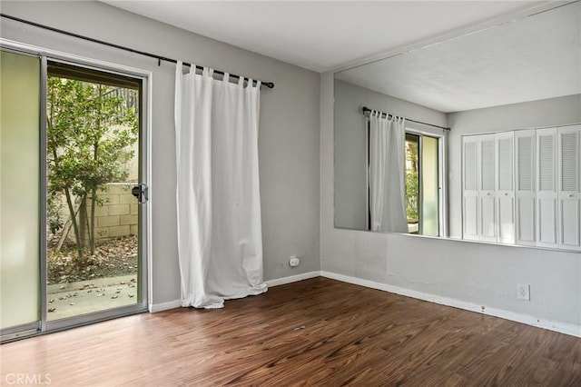 spare room with dark wood-type flooring