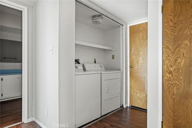 laundry area featuring separate washer and dryer and dark wood-type flooring