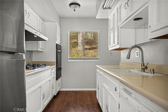 kitchen featuring sink, dark hardwood / wood-style flooring, white cabinetry, and stainless steel appliances