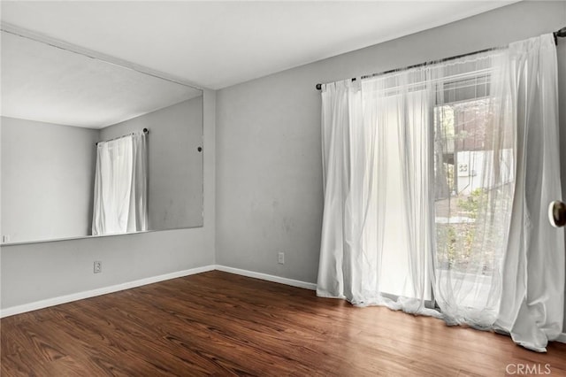 spare room with dark wood-type flooring