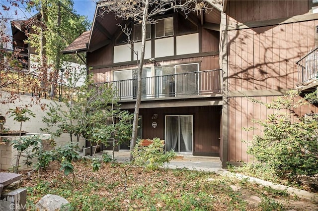 back of house featuring a balcony