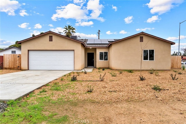 single story home featuring a garage and solar panels