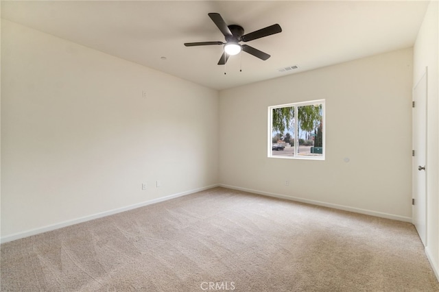 carpeted spare room featuring ceiling fan