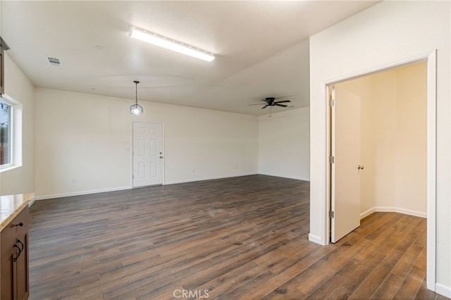 spare room with ceiling fan and dark hardwood / wood-style floors