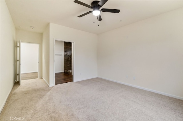 unfurnished bedroom featuring ceiling fan and light colored carpet